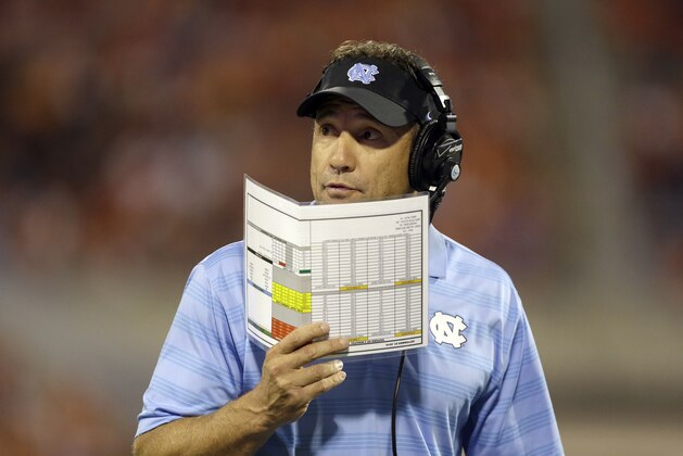 North Carolina head coach Larry Fedora calls a play during the first half of an NCAA college football game against North Carolina in Clemson, S.C., Saturday Sept. 27, 2014. Clemson won 50-35. (AP Photo/Bob Leverone)