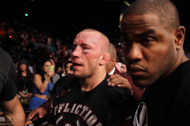 Georges St. Pierre, of Canada, exits the octagon following a UFC 167 mixed martial arts championship welterweight bout against Johny Hendricks on Saturday, Nov. 16, 2013, in Las Vegas. St. Pierre won by split decision. (AP Photo/Isaac Brekken)