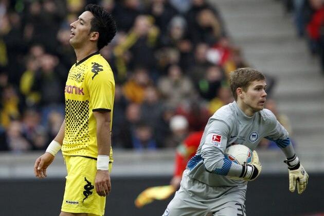Dortmund's Lucas Barrios of Paraguay, left, reacts as Berlin's goalkeeper Thomas Kraft, right, catches the ball during the German first division Bundesliga soccer match between Hertha BSC Berlin and Borussia Dortmund in Berlin, Germany, Saturday, Feb. 18, 2012. Dortmund defeated Berlin by 1-0. (AP Photo/Michael Sohn)
