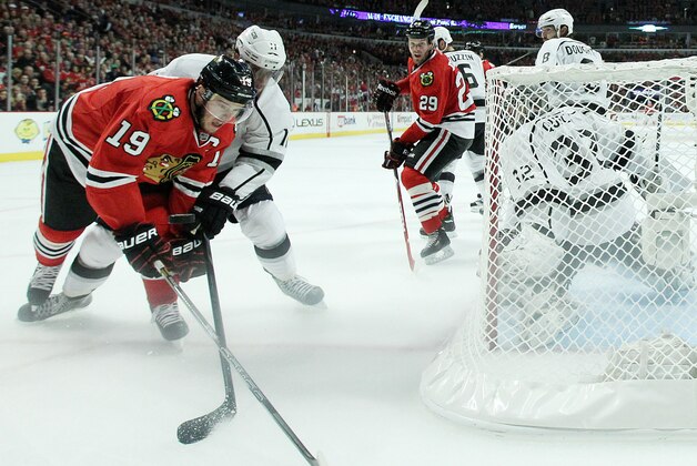 CHICAGO, IL - MAY 18:  Jonathan Toews #19 of the Chicago Blackhawks and Anze Kopitar #11 of the Los Angeles Kings vie for the puck in Game One of the Western Conference Final during the 2014 Stanley Cup Playoffs at United Center on May 18, 2014 in Chicago, Illinois.  (Photo by Jonathan Daniel/Getty Images)