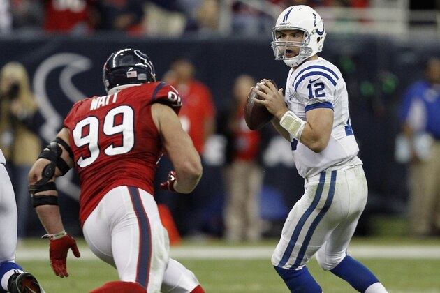 HOUSTON, TX - NOVEMBER 03: Andrew Luck #12 of the Indianapolis Colts drops back as J.J. Watt #99 of the Houston Texans applies pressure in the fourth quarter at Reliant Stadium on November 3, 2013 in Houston, Texas. (Photo by Bob Levey/Getty Images)