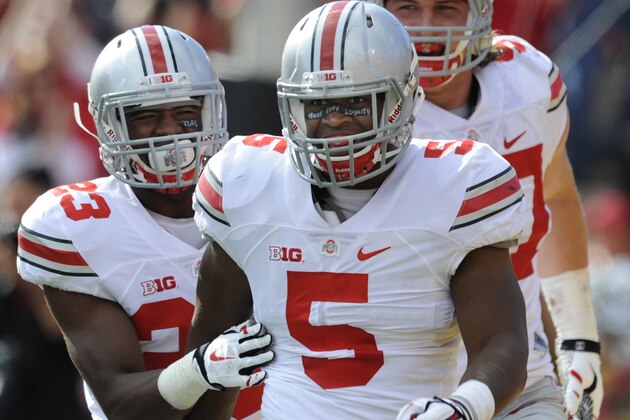Ohio State's linebacker Raekwon McMillan, (5), celebrates after his interception and touchdown with Tyvis Powell, (23), and Joey Bosa, (97), in the second half of an NCAA college football game against Maryland in College Park, Md., Saturday, Oct. 4, 2014. Ohio state won 52-24.(AP Photo/Gail Burton)