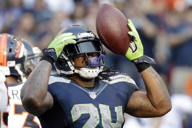 Seattle Seahawks' Marshawn Lynch reacts after rushing for a first down against the Denver Broncos in overtime of an NFL football game, Sunday, Sept. 21, 2014, in Seattle. The Seahawks won 26-20. (AP Photo/Elaine Thompson)