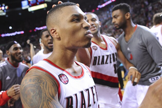 FILE - In this May 2, 2014, file photo, Portland Trail Blazers' Damian Lillard, center, celebrates with teammates after his winning shot against the Houston Rockets during the last .9 of a second of Game 6 of an NBA basketball first-round playoff series game in Portland, Ore. Lillard's star was already on the rise. Then came The Shot _ his buzzer-beating 3-pointer against the Rockets that sent the Trail Blazers into the second round of the playoffs for the first time in 14 years. (AP Photo/Greg Wahl-Stephens, File)