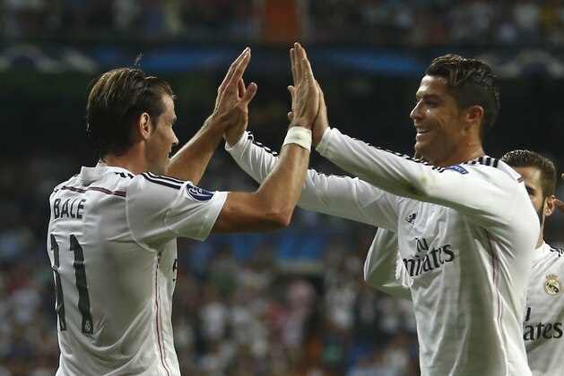 Real Madrid's Gareth Bale celebrates with teammate Cristiano Ronaldo scoring his side's 2nd goal during the Champions League Group B soccer match between Real Madrid and Basel at the Santiago Bernabeu stadium in Madrid, Spain, Tuesday Sept. 16, 2014. (AP Photo/Andres Kudacki)