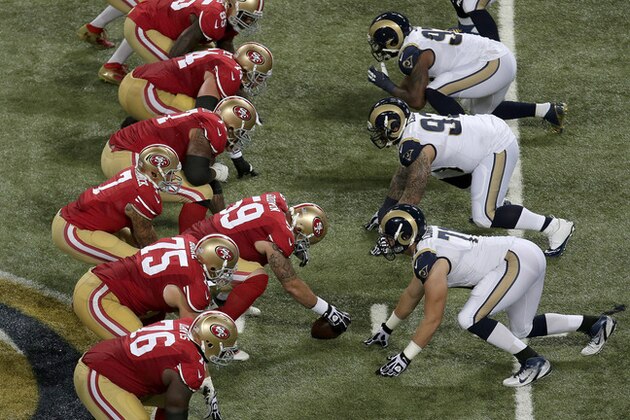 Players for the San Francisco 49ers and the St. Louis Rams face off at the line of scrimmage during the third quarter of an NFL football game Thursday, Sept. 26, 2013, in St. Louis. (AP Photo/Charlie Riedel)