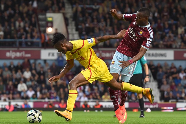 Liverpool’s Raheem Sterling, left, competes for the ball with West Ham United’s Diafra Sakho during their English Premier League soccer match at Upton Park, London, Saturday, Sept. 20, 2014. (AP Photo/Tim Ireland)