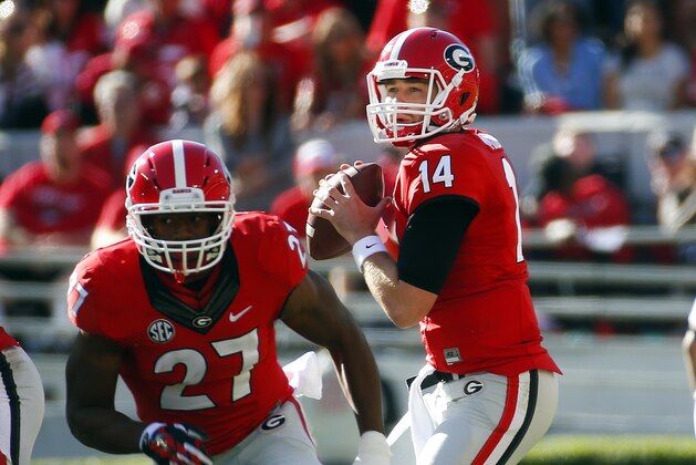 Georgia quarterback Hutson Mason (14) looks for a receiver as Georgia running back Nick Chubb (27) runs a pass route in the first half of an NCAA college football game against Vanderbilt  Saturday, Oct. 4, 2014, in Athens, Ga. Georgia won 44-17.  (AP Photo/John Bazemore)