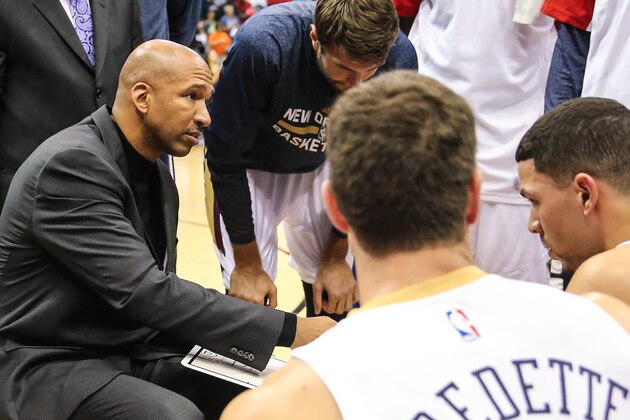 New Orleans Pelicans, left, head coach Monty Williams talks with his palyers during the first half of an NBA preseason basketball game against the Washington Wizards in Jacksonville, Fla., Wednesday, Oct. 8, 2014. (AP Photo/Gary McCullough)