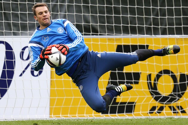 Goalkeeper Manuel Neuer makes a save during a training session of Germany's national soccer team in Frankfurt, Germany, Tuesday, Oct. 7, 2014. Germany will play against Poland in a group D qualifying match for the Euro 2016 in Warsaw next Saturday. (AP Photo/Michael Probst)