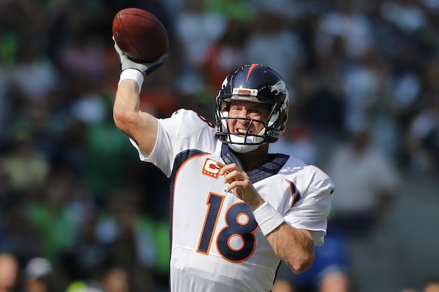 Denver Broncos quarterback Peyton Manning throws against the Seattle Seahawks in the first half of an NFL football game, Sunday, Sept. 21, 2014, in Seattle. (AP Photo/John Froschauer)