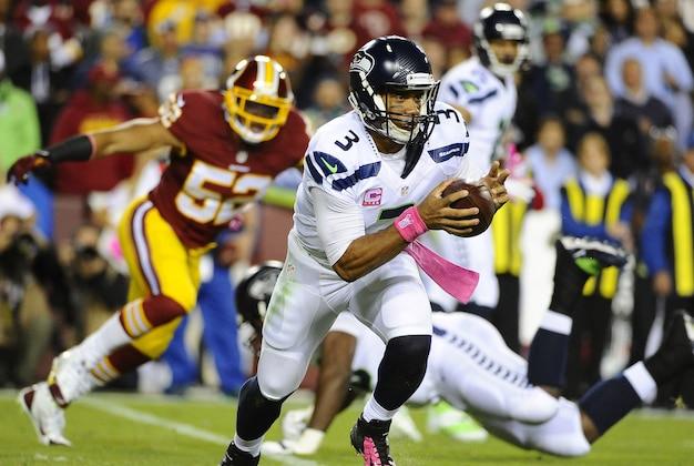 Oct 6, 2014; Landover, MD, USA; Seattle Seahawks quarterback Russell Wilson (3) rushes the ball against the Washington Redskins during the first half at FedEx Field. Mandatory Credit: Brad Mills-USA TODAY Sports