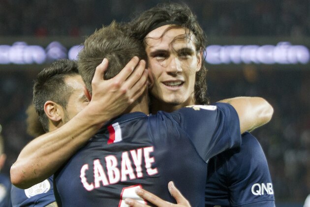 Paris Saint Germain's Edinson Cavani , right, celebrates his goal against Olympic Lyonnais with Yohan Cabaye during their French League One soccer match Sunday, Sept. 21, 2014, at Parc des Princes stadium, in Paris, France. (AP Photo/Jacques Brinon)