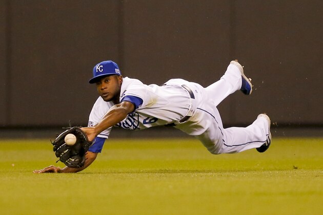Kansas City Royals center fielder Lorenzo Cain (6) makes a leaping catch for a ball hit by Los Angeles Angels' Albert Pujols (5) during the fifth inning of Game 3 of baseball's AL Division Series in Kansas City, Mo., Sunday, Oct. 5, 2014. (AP Photo/Travis Heying)