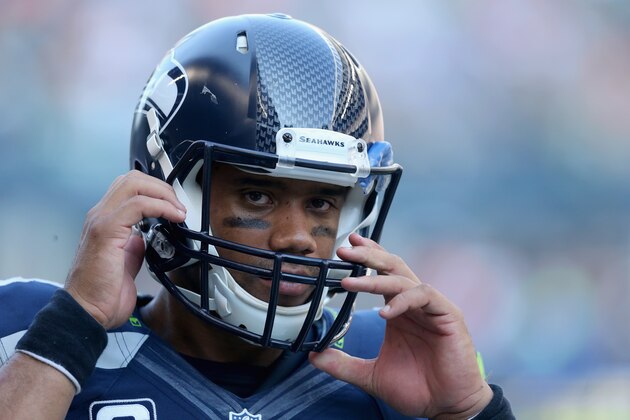 SEATTLE, WA - SEPTEMBER 21:  Quarterback Russell Wilson #3 of the Seattle Seahawks adjusts his helmet against the Denver Broncos at CenturyLink Field on September 21, 2014 in Seattle, Washington.  (Photo by Jeff Gross/Getty Images)