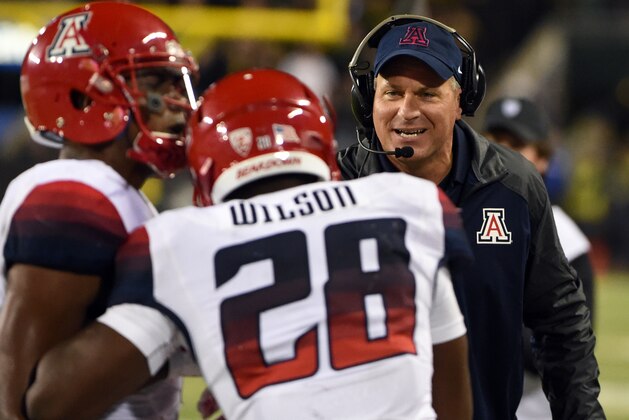 Arizona head coach Rich Rodriguez celebrates with running back Nick Wilson (28) after Wilson scored a touchdown during the third quarter of the NCAA college football game against Oregon at Autzen Stadium on Thursday, Oct. 2, 2014, in Eugene, Ore. Arizona won the game 31-24. (AP Photo/Steve Dykes)