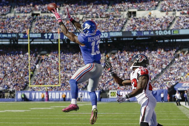 New York Giants wide receiver Odell Beckham (13) makes a touchdown catch on a pass from quarterback Eli Manning, not pictured, as Atlanta Falcons cornerback Robert Alford defends on the play during the second half of an NFL football game, Sunday, Oct. 5, 2014, in East Rutherford, N.J. (AP Photo/Seth Wenig)