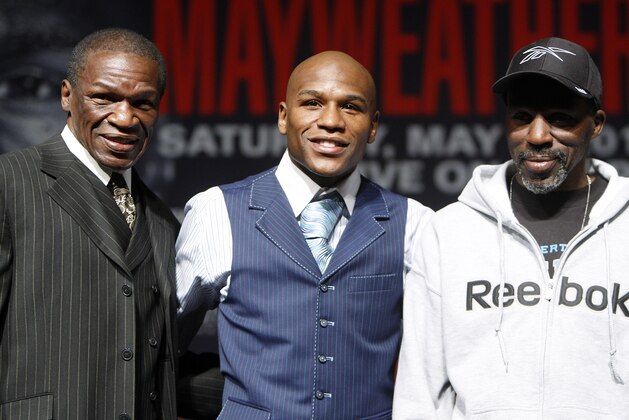 Floyd Mayweather Sr., left, Floyd Mayweather Jr. center, and Roger Mayweather pose for photos during a boxing news conference at the MGM Grand Wednesday, April 28, 2010 in Las Vegas. Mayweather Jr., will challenge Shane Mosley for his WBA welterweight title on Saturday, May 1. (AP Photo/Isaac Brekken)