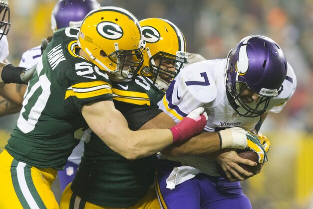Oct 2, 2014; Green Bay, WI, USA; Minnesota Vikings quarterback Christian Ponder (7) is sacked during the game against the Green Bay Packers at Lambeau Field.  Green Bay won 42-10.  Mandatory Credit: Jeff Hanisch-USA TODAY Sports
