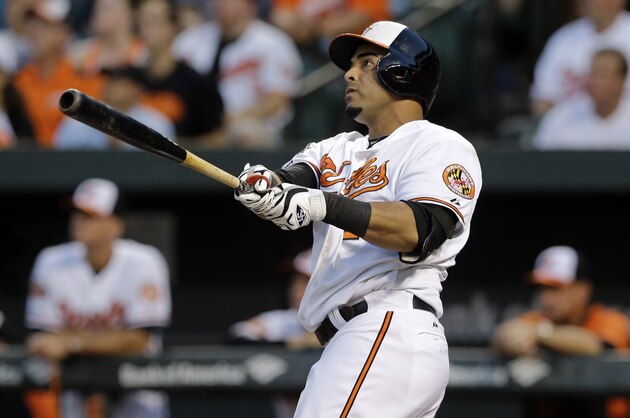 Baltimore Orioles' Nelson Cruz watches his two-run home run in the first inning of an interleague baseball game against the Cincinnati Reds, Thursday, Sept. 4, 2014, in Baltimore. (AP Photo/Patrick Semansky)