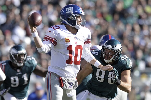 New York Giants quarterback Eli Manning (10) is pressured by Philadelphia Eagles' Connor Barwin (98) during the second half of an NFL football game Sunday, Oct. 27, 2013 in Philadelphia. (AP Photo/Michael Perez)