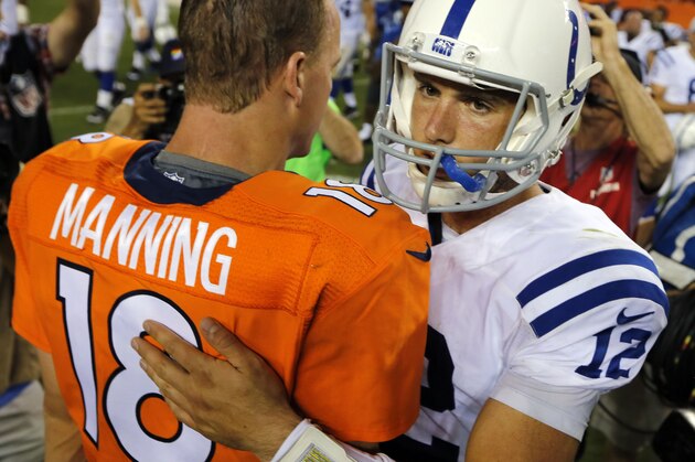 Denver Broncos quarterback Peyton Manning (18) greets Indianapolis Colts quarterback Andrew Luck (12) after an NFL football game, Sunday, Sept. 7, 2014, in Denver. The Broncos won 31-24. (AP Photo/Jack Dempsey)
