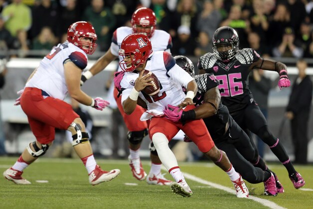Oct 2, 2014; Eugene, OR, USA; Oregon Ducks defensive lineman DeForest Buckner (44) sacks Arizona Wildcats quarterback Anu Solomon (12) at Autzen Stadium. Mandatory Credit: Scott Olmos-USA TODAY Sports