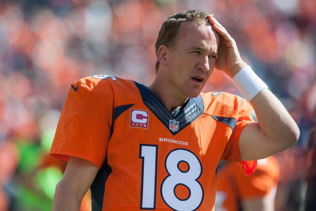 DENVER, CO - OCTOBER 5:  Quarterback Peyton Manning #18 of the Denver Broncos wipes his brow before the start of a game against the Arizona Cardinals at Sports Authority Field at Mile High on October 5, 2014 in Denver, Colorado.  (Photo by Dustin Bradford/Getty Images)