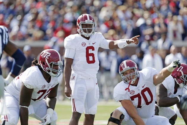 Alabama quarterback Blake Sims (6) and offensive lineman Ryan Kelly (70) gesture during the first  half of an NCAA college football game against Mississippi in Oxford, Miss., Saturday, Oct. 4, 2014. No. 11 Mississippi won 23-17. (AP Photo/Rogelio V. Solis)