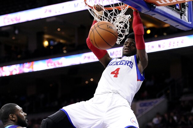 Philadelphia 76ers' Nerlens Noel (4) dunks over Charlotte Hornets' Jason Maxiell during the second half of a preseason NBA basketball game in Philadelphia, Wednesday, Oct. 8, 2014. The 76ers won 106-92. (AP Photo/Michael Perez)