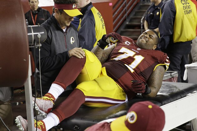 Washington Redskins tackle Trent Williams (71) is treated along the sidelines after an injury during the second half of an NFL Thursday night football game against the New York Giants in Landover, Md., Thursday, Sept. 25, 2014. The Giants defeated the Redskins 45-14. (AP Photo/Patrick Semansky)