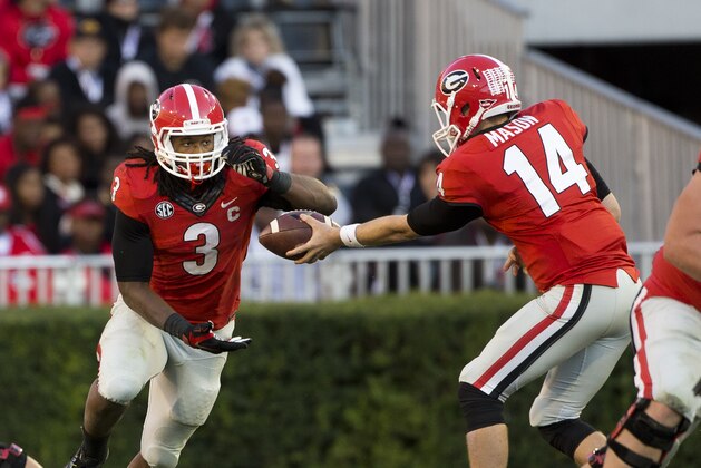 Georgia quarterback Hutson Mason (14) hands off to Georgia running back Todd Gurley (3) in the second  half of an NCAA college football game against Vanderbilt  Saturday, Oct. 4, 2014, in Athens, Ga.. Georgia won 44-17. (AP Photo/John Bazemore)