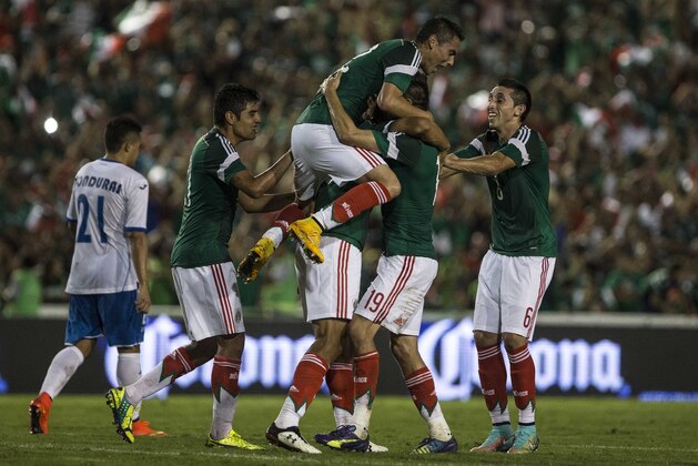 Mexico's Oswaldo Alanis celebrates with teammates after scoring against Honduras during a friendly soccer match, in Tuxtla Gutierrez, Thursday, Oct.  9, 2014. (AP Photo/Christian Palma)