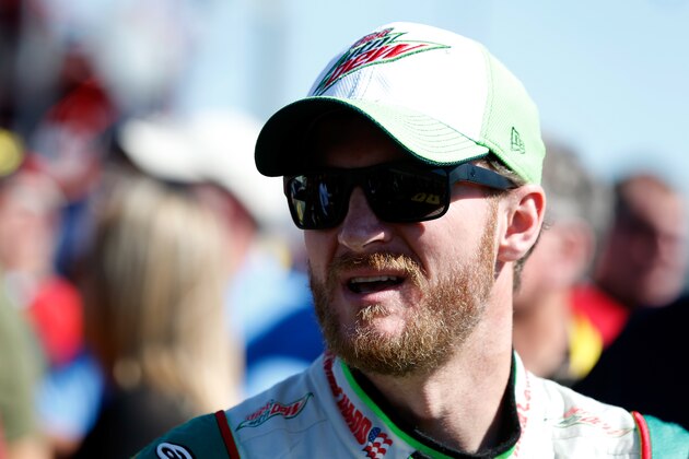 KANSAS CITY, KS - OCTOBER 05:  Dale Earnhardt Jr., driver of the #88 Diet Mountain Dew Chevrolet, stands on the grid before the NASCAR Sprint Cup Series Hollywood Casino 400 at Kansas Speedway on October 5, 2014 in Kansas City, Kansas.  (Photo by Sean Gardner/Getty Images)