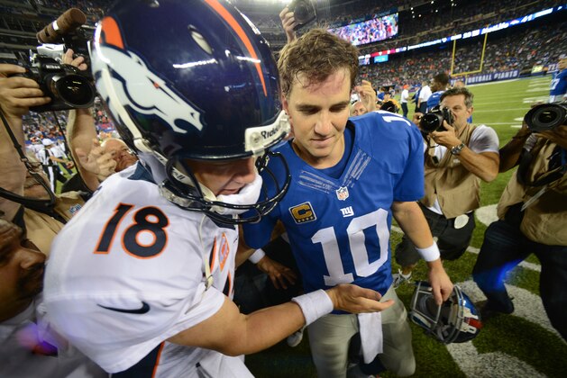 EAST RUTHERFORD, NJ - SEPTEMBER 15: Quarterback Peyton Manning #18 of the Denver Broncos and brother quarterback Eli Manning #10 of the New York Giants shake hands at the end of the Denver Broncos 41-23 win over the New York Giants at MetLife Stadium on September 15, 2013 in East Rutherford, New Jersey. (Photo by Ron Antonelli/Getty Images)