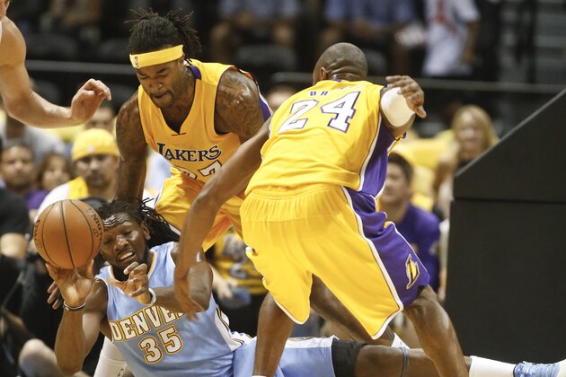 Denver Nuggets forward Kenneth Faried gets a pass away as Los Angeles Lakers guard Kobe Bryant, right, and Jordan Hill try for the steal during the first half of a NBA preseason basketball game  Monday, Oct. 6, 2014, in San Diego. (AP Photo/Lenny Ignelzi