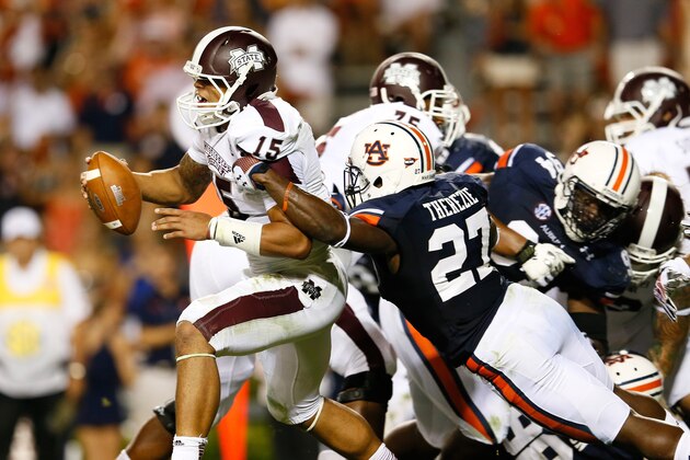 AUBURN, AL - SEPTEMBER 14:  Robenson Therezie #27 of the Auburn Tigers tackles Dak Prescott #15 of the Mississippi State Bulldogs at Jordan-Hare Stadium on September 14, 2013 in Auburn, Alabama.  (Photo by Kevin C. Cox/Getty Images)