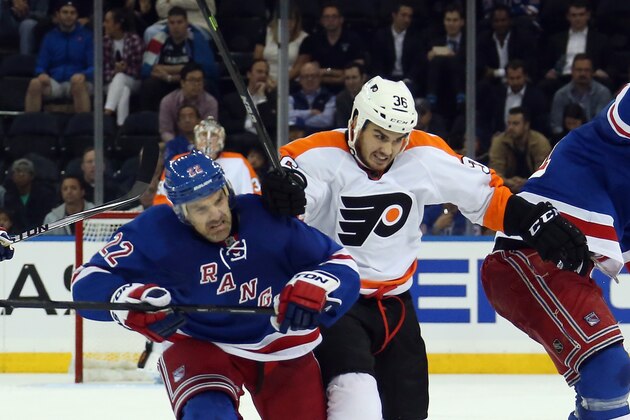 NEW YORK, NY - SEPTEMBER 29: Dan Boyle #22 of the New York Rangers and Zac Rinaldo #36 of the Philadelphia Flyers collide at Madison Square Garden on September 29, 2014 in New York City. The Rangers defeated the Flyers 6-3.  (Photo by Bruce Bennett/Getty Images)