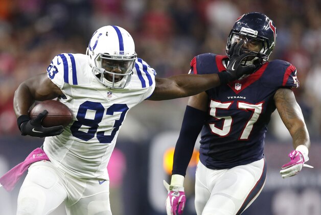 Oct 9, 2014; Houston, TX, USA; Indianapolis Colts tight end Dwayne Allen (83) stiff arms Houston Texans linebacker Justin Tuggle (57) after a reception in the first quarter at NRG Stadium. Mandatory Credit: Matthew Emmons-USA TODAY Sports Oct 9, 2014; Houston, TX, USA; Indianapolis Colts tight end Dwayne Allen (83) stiff arms Houston Texans linebacker Justin Tuggle (57) after a reception in the first quarter at NRG Stadium. Mandatory Credit: Matthew Emmons-USA TODAY Sports
