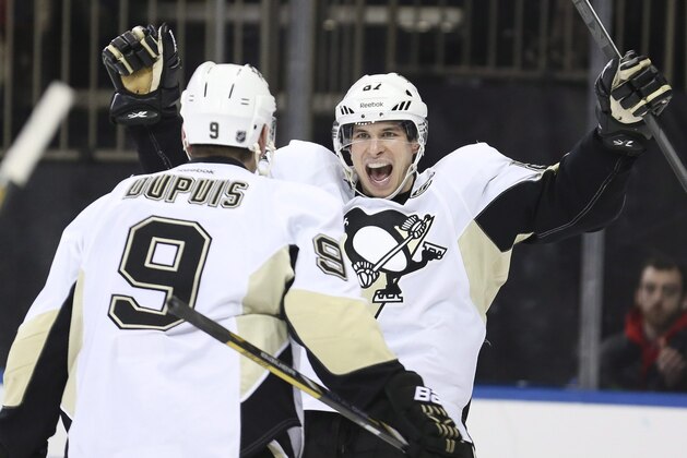 FILE - In this Dec. 18, 2013 file photo, Pittsburgh Penguins center Sidney Crosby (87) reacts after right wing Pascal Dupuis (9) scored during the third period of an NHL hockey game against the New York Rangers in New York. Crosby was named to Canada's men's national hockey team for the Sochi Olympics on Tuesday, Jan. 7, 2014.  (AP Photo/John Minchillo, File)