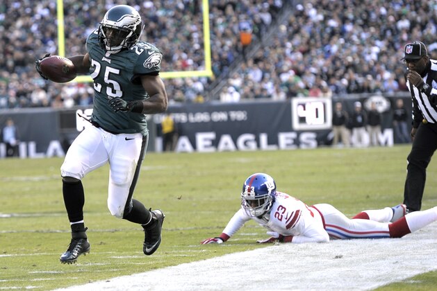 Philadelphia Eagles' LeSean McCoy (25) runs away from New York Giants cornerback Corey Webster (23)  during the first half of an NFL football game Sunday, Oct. 27, 2013 in Philadelphia. (AP Photo/Michael Perez)