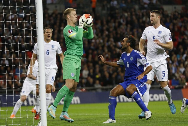 England's Joe Hart makes a save in front of San Marino's Alessandro Della Valle during the Euro 2016 group E qualifying match between England and San Marino at Wembley stadium in London, Thursday, Oct. 9, 2014. (AP Photo/Kirsty Wigglesworth)