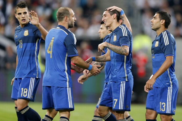 Argentina's players celebrate their side's fourth goal by Angel Di Maria, 2nd right, during the friendly soccer match between Germany and Argentina in Duesseldorf, Germany, Wednesday, Sept. 3, 2014. (AP Photo/Frank Augstein)