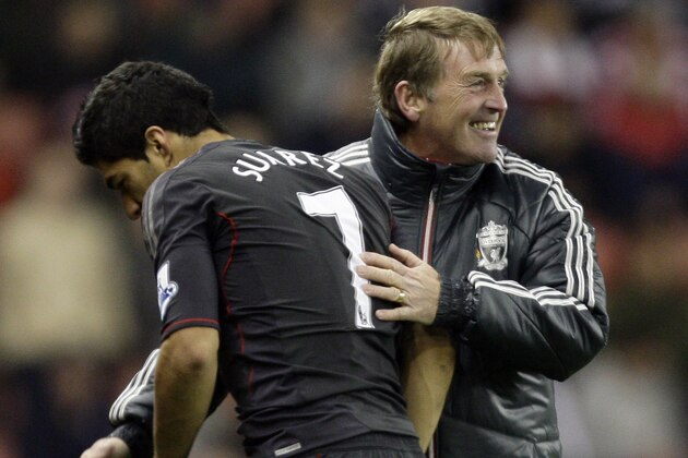Liverpool's Luis Suarez, left, is congratulated by his manager Kenny Dalglish as he is substituted after scoring the winning goal in his team's 2-1 victory over Stoke in their English League Cup soccer match at the Britannia Stadium, Stoke, England, Wednesday Oct. 26, 2011. (AP Photo/Jon Super)