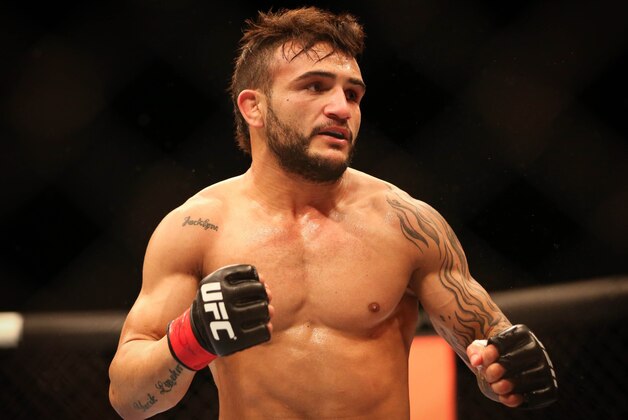 Jul 16, 2014; Atlantic City, NJ, USA; John Lineker (red gloves) faces off against Alptekin Ozkilic (not pictured) during a flyweight bout at Revel Casino. Mandatory Credit: Bill Streicher-USA TODAY Sports