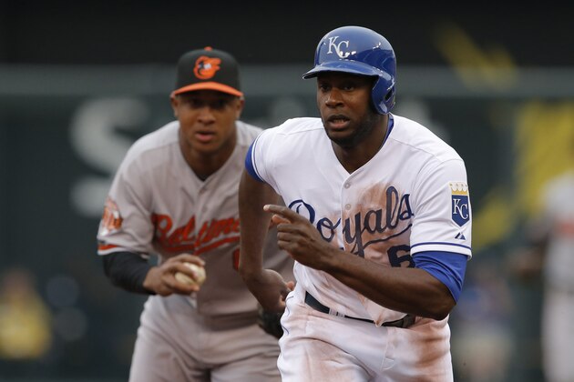 Kansas City Royals' Lorenzo Cain (6) get caught in a rundown between Baltimore Orioles second baseman Jonathan Schoop, back, and third baseman Manny Machado during the second inning of a baseball game at Kauffman Stadium in Kansas City, Mo., Saturday, May 17, 2014. Cain was tagged out by Machado. (AP Photo/Orlin Wagner)
