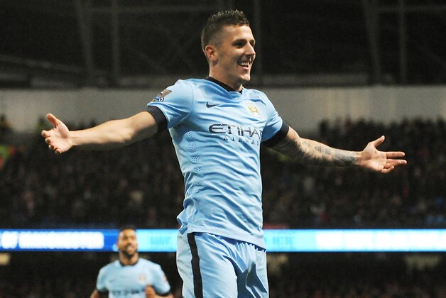 Manchester City's Stevan Jovetic celebrates after scoring his second goal against Liverpool during the English Premier League soccer match between Manchester City and Liverpool at the Etihad Stadium, in Manchester, England, Monday, Aug. 25, 2014. (AP Photo/Rui Vieira)