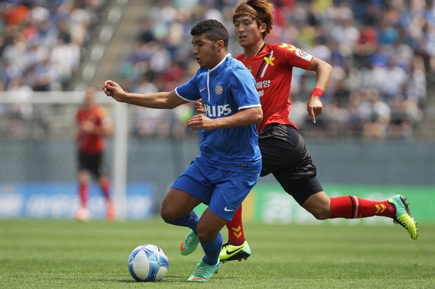 CHANGWON, SOUTH KOREA - MAY 24:  Zakaria Bakkali of PSV Eindhoven compete for the ball with Lee Han-Sam of Gyeongnam FC during the friendly match between PSV Eindhoven and Gyeongnam FC at Changwon Stadium on May 24, 2014 in Changwon, South Korea.  (Photo by Chung Sung-Jun/Getty Images)
