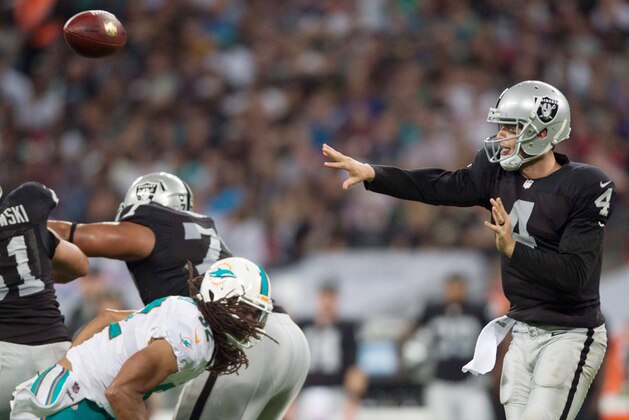 Sep 28, 2014; London, UNITED KINGDOM;  Oakland Raiders quarterback Derek Carr (4) throws the ball during the second half against the Miami Dolphins at Wembley Stadium. Mandatory Credit: Steve Flynn-USA TODAY Sports