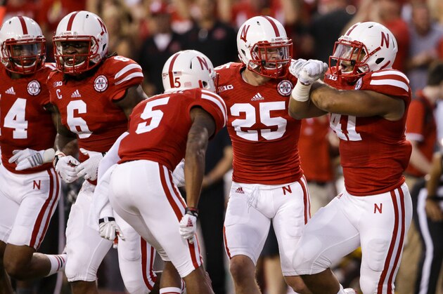 Nebraska linebacker David Santos (41), defensive back Nate Gerry (25), cornerback Josh Mitchell (5), safety Corey Cooper (6) and defensive end Randy Gregory (4) celebrate an interception by Santos in the first half of an NCAA college football game against Miami in Lincoln, Neb., Saturday, Sept. 20, 2014. (AP Photo/Nati Harnik)